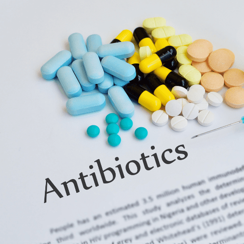 Various antibiotic capsules in a container